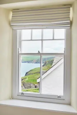 a window with a view of the ocean at Outlaw's Guest House in Port Isaac
