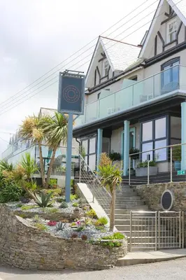 a building with a clock in front of it at Outlaw's Guest House in Port Isaac