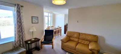 a living room with a couch and a table at Penaflor in Perranporth
