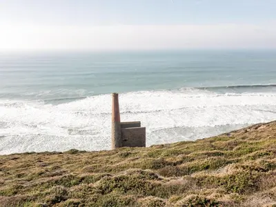 a smoke stack on a beach near the ocean at Skylarks! in St. Agnes