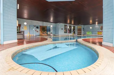 a large swimming pool in a building at Skylarks! in St. Agnes