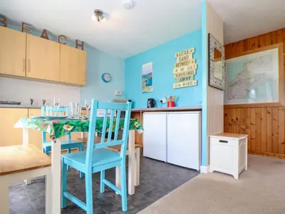 a kitchen and dining room with a table and chairs at Skylarks! in St. Agnes