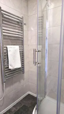 a shower with a glass door in a bathroom at 5 Penhale in Perranporth