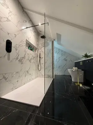 a bathroom with a glass shower and a toilet at Moorswater Lodge Country House with Wine Bar in Liskeard