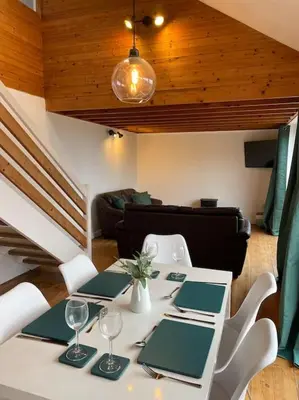 a dining room with a white table and chairs at House with stunning sea views in Downderry