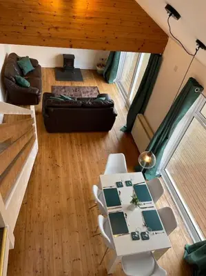 an overhead view of a living room with a table and chairs at House with stunning sea views in Downderry