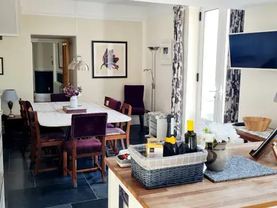 a kitchen and dining room with a table and chairs at Stunning 4 bedroom house in Wadebridge, Cornwall - 2 living rooms and superking beds in Wadebridge