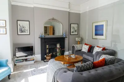 a living room with two couches and a table at Stunning 4 bedroom house in Wadebridge, Cornwall - 2 living rooms and superking beds in Wadebridge