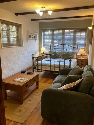 a living room with a bed and a couch at Apartment in lovely village in Newquay