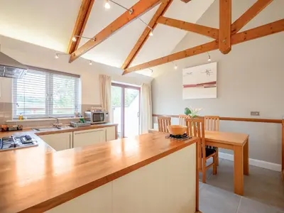 a kitchen with a wooden counter top and a table at Villa Gallery-77 in Perranwell