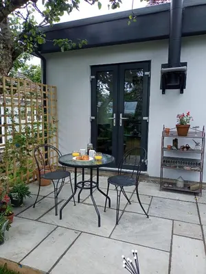 a patio with a table and chairs on a patio at Hygga in Fowey