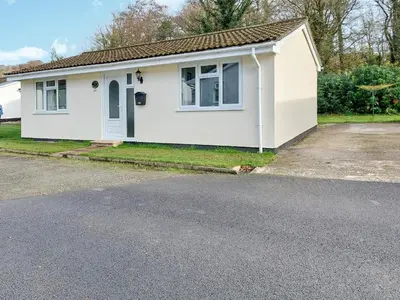 a white house with a driveway at Stone The Crows in Liskeard