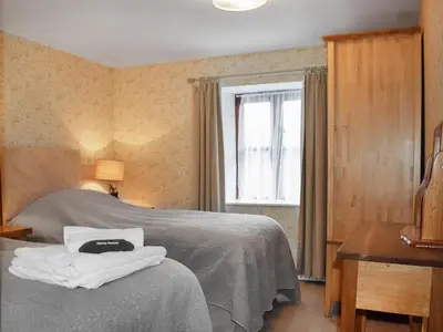 a bedroom with a bed and a window at Grain Store 1 - 29635 in Portloe
