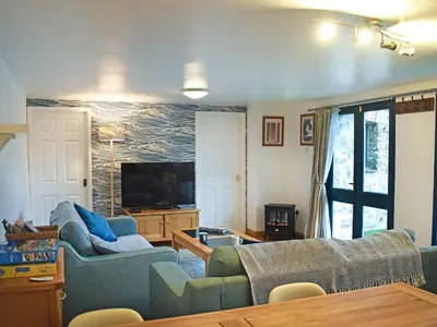 a living room with two couches and a tv at Grain Store 2 - 29636 in Portloe