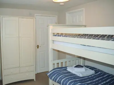 a bedroom with a bunk bed and a closet at Grain Store 2 - 29636 in Portloe