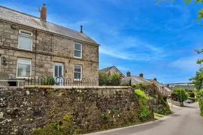 a stone house with a stone wall and a street at Finest Retreats - Greenbank in Saint Dennis