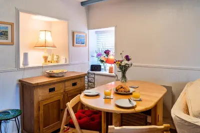 a kitchen with a table and a dining room at Finest Retreats - Greenbank in Saint Dennis