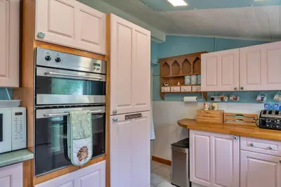 a kitchen with white cabinets and an oven at Finest Retreats - Greenbank in Saint Dennis