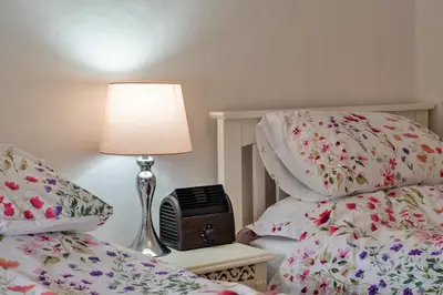 a bedroom with two twin beds and a lamp and a bedside alarm clock at Finest Retreats - Greenbank in Saint Dennis