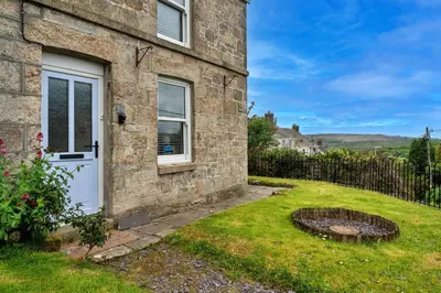 a stone house with a door and a yard at Finest Retreats - Greenbank in Saint Dennis
