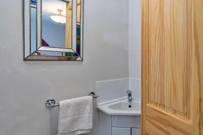 a bathroom with a sink and a mirror at Finest Retreats - Greenbank in Saint Dennis