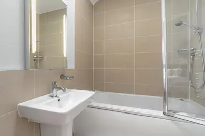 a bathroom with a sink and a shower and a tub at The Glades - Retallack in Saint Columb Major