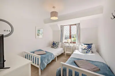 a bedroom with two beds and a window at 4 Bed in Padstow oc-s29537 in Padstow