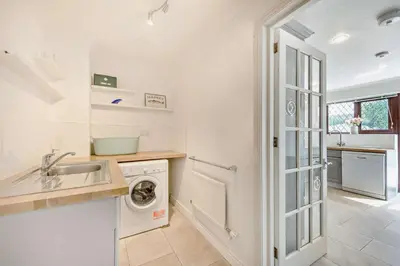 a kitchen with a washing machine and a sink at 4 Bed in Padstow oc-s29537 in Padstow