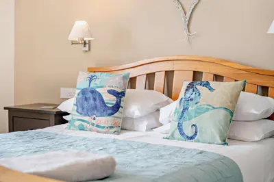 a bed with blue and white pillows on it at 4 Bed in Padstow oc-s29537 in Padstow