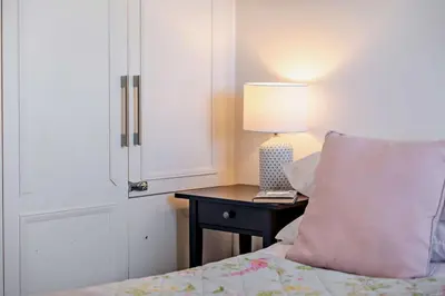 a bedroom with a bed and a table with a lamp at 4 Bed in Padstow oc-s29537 in Padstow