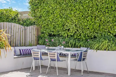 a table and chairs sitting on a patio at 4 Bed in Padstow oc-s29537 in Padstow