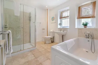 a bathroom with a tub and a shower and a toilet at 5 Bed in Trebetherick oc-b29371 in Polzeath