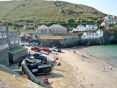 a beach with a group of people and vehicles on it at Hillside in Port Isaac