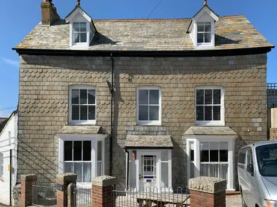 a house with a car parked in front of it at Hillside in Port Isaac