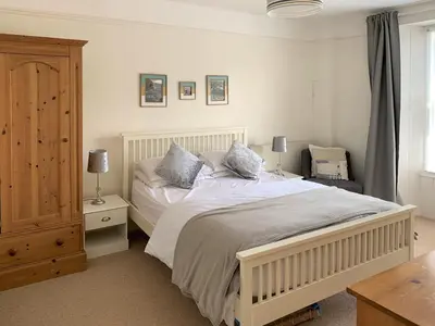a bedroom with a white bed with two pillows at Hillside in Port Isaac