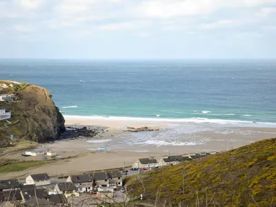 a view of a beach with houses and the ocean at Porhellik in Zelah