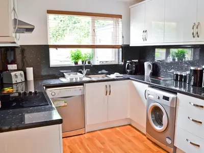 a kitchen with a sink and a dishwasher at Porhellik in Zelah