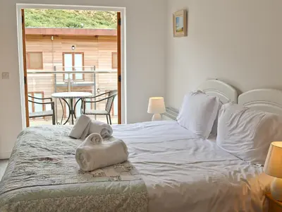 a bedroom with a bed with a towel on it at Porhellik in Zelah