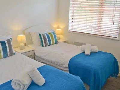 a bedroom with two beds with towels on them at Porhellik in Zelah