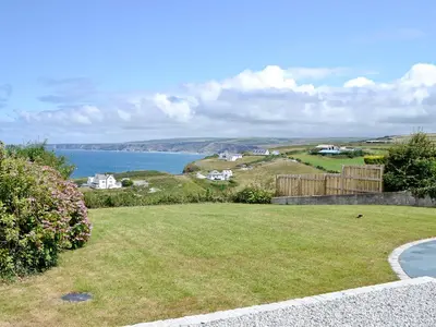 a grassy yard with a view of the ocean at Sea Vista in Port Isaac