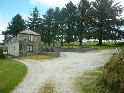 an old stone building on a dirt road at HOPSLAND HOLIDAYS Byre, Dairy & Hayloft in Saint Cleer