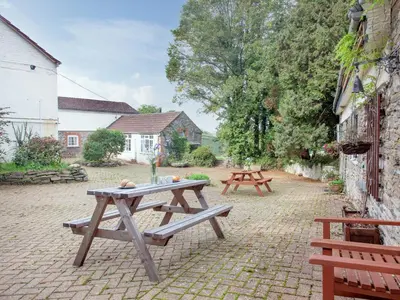 a picnic table and two benches in a courtyard at Byre in Saint Martin