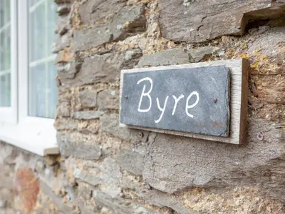 a sign on the side of a brick building with the word hype at Byre in Saint Martin