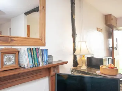 a room with a counter with a clock and a lamp at Byre in Saint Martin