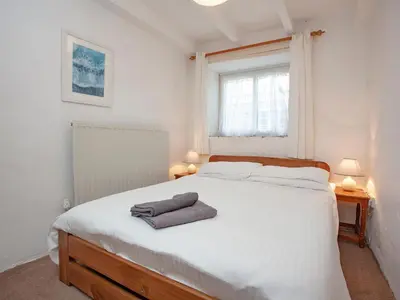 a bedroom with a white bed with two towels on it at Smithy in Saint Martin