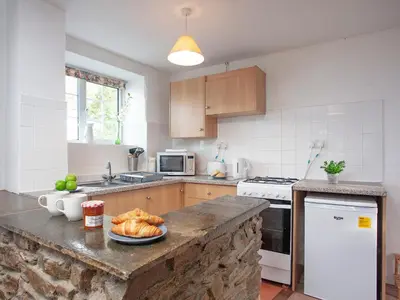 a kitchen with a table with a plate of bread at Smithy in Saint Martin
