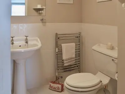a bathroom with a toilet and a sink at Waterside in Fowey