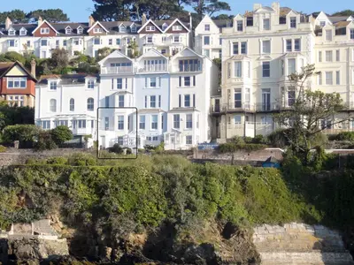 a group of houses on a hill next to a river at Waterside in Fowey