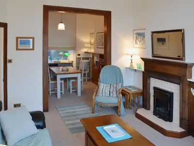 a living room with a couch and a fireplace at Waterside in Fowey