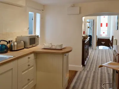 a kitchen with a counter top with a microwave at Waterside in Fowey